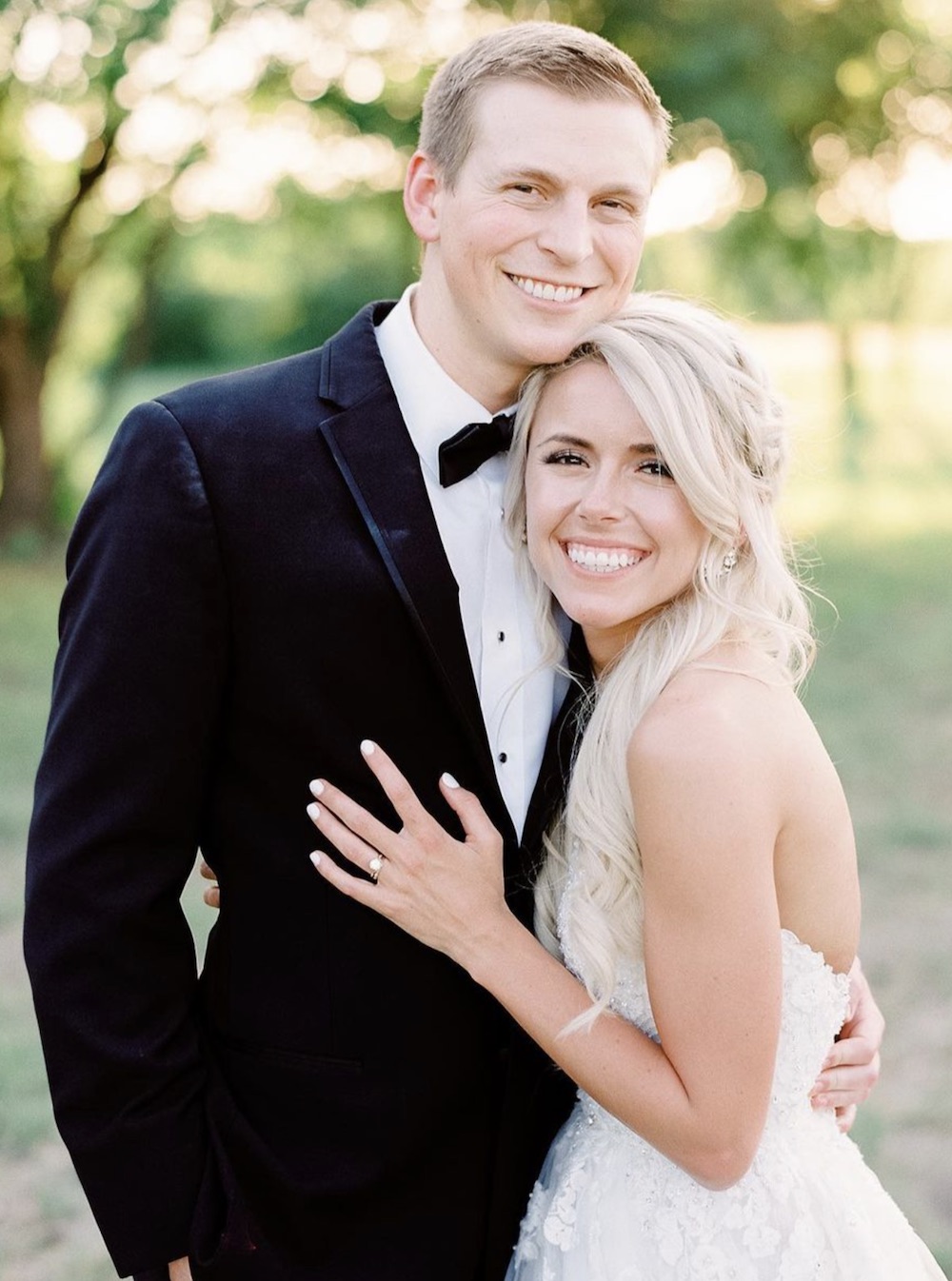Mackenzie Reiter posing for a portrait photo with her husband on their wedding day