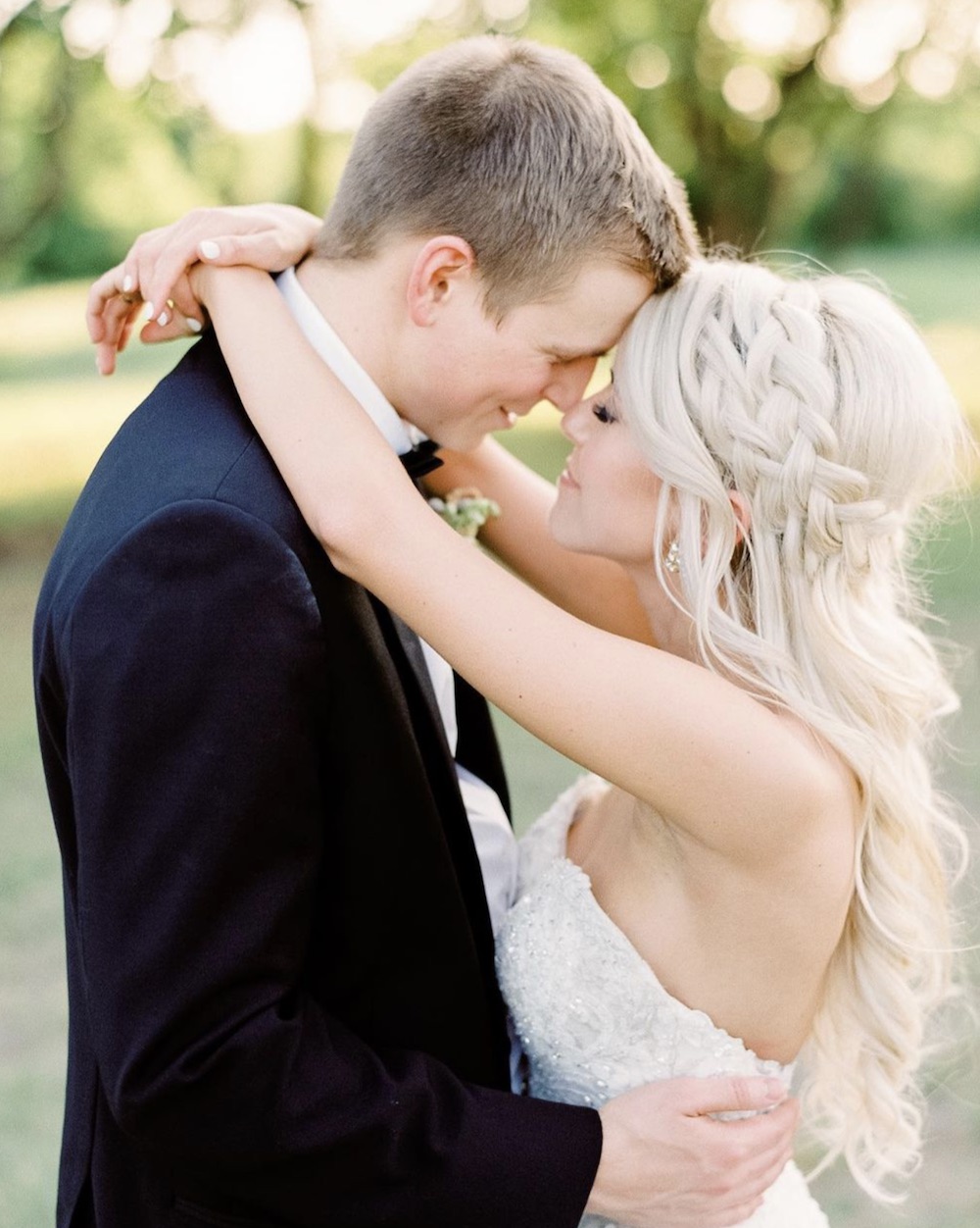 Mackenzie Reiter and husband sharing a hug and pressing their foreheads against each other on their wedding day 