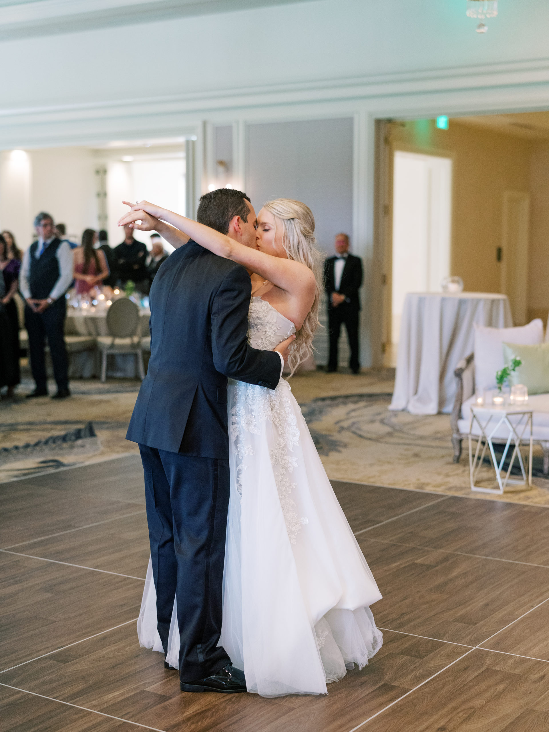 Bride and groom sharing a kiss as the slow dance on the dance floor at the Grand Ballroom in the Lakeside Country Club